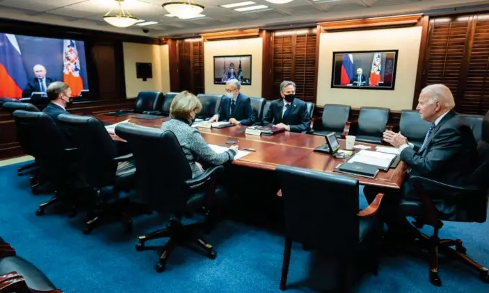  ?? Photograph: The White House/AFP/Getty Images ?? Joe Biden is seen speaking with Vladimir Putin on a screen in an image released by the White House on 7 December.