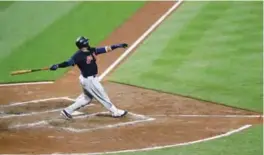  ??  ?? BALTIMORE: Cleveland Indians’ Carlos Santana hits a sacrifice fly ball in the sixth inning of a baseball game against the Baltimore Orioles in Baltimore, Monday. Jose Ramirez scored on the play. Cleveland won 12-0.—AP