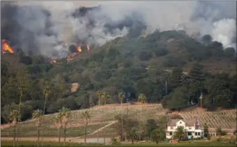  ?? STEPHEN LAM / REUTERS ?? Flames burn on a hillside near Napa Road in Sonoma, California on Monday.