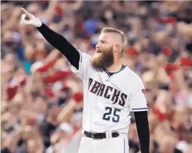  ?? MATT YORK/ASSOCIATED PRESS ?? Arizona relief pitcher Archie Bradley celebrates his two-run triple against the Rockies in the seventh inning of the National League wild-card game in Phoenix.