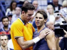  ?? ADAM HUNGER — THE ASSOCIATED PRESS ?? Juan Martin del Potro talks with Rafael Nadal after Nadal retired from the match during the semifinals of the U.S. Open on Friday.