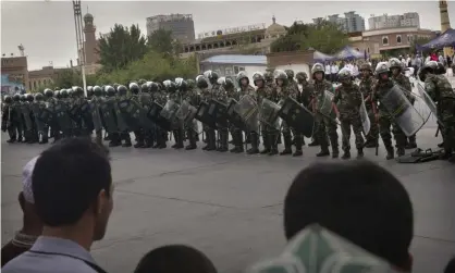  ??  ?? Chinese soldiers in riot gear stand outside a mosque in Kashgar, in Xinjiang province. Photograph: Kevin Frayer/Getty Images