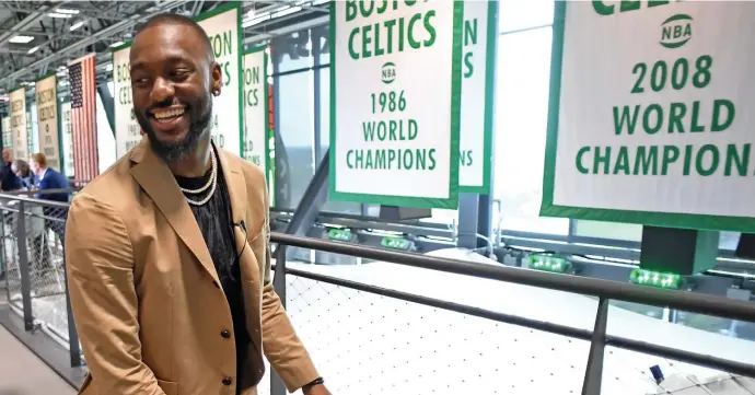  ?? Herald staFF FIle ?? THIS ONCE WAS A SPORTS TOWN: Kemba Walker walks past Boston Celtics’ World Championsh­ip banners after he was introduced as a new member of the team at the Auerbach Center last July. Pro teams in Massachuse­tts just heard they can start practicing next week, but there’s no word own when they might hold games.