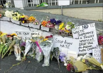  ?? Candice Choi Associated Press ?? A MAKESHIFT MEMORIAL after the March shootings. “The prosecutor and [killer] were on the same side of white supremacy,” said activist Stephanie Cho, arguing the slayings were clearly race- and gender-based.