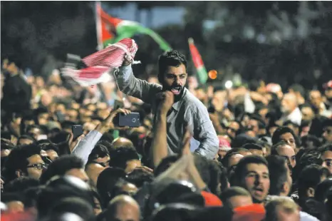  ?? AFP ?? Protesters voice their rage during a demonstrat­ion against tax proposals outside the prime minister’s office in Amman. Prime Minister Omar Razzaz, below, and colleagues have their work cut out in selling their measures to an angry public