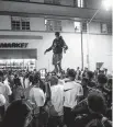  ?? DANIEL A. VARELA dvarela@miamiheral­d.com ?? A man stands on a car as spring break crowds gather an hour past curfew in Miami Beach on March 21.