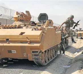  ??  ?? OFFENSIVE A Turkish soldier arrives with a tank that will be given to Syrian forces