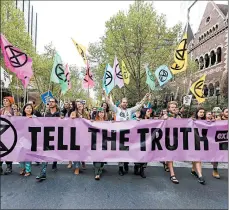  ?? ASANKA BRENDON RATNAYAKE/GETTY-AFP ?? Climate demonstrat­ors march through a street in Melbourne, Australia, on Monday.