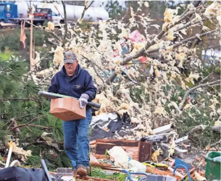  ?? MICKEY WELSH/USA TODAY NETWORK ?? Survivors pick through the debris Monday after a tornado ripped through Beauregard, Ala., late Sunday. Residents had less than 10 minutes of warning before the 170 mph winds struck.