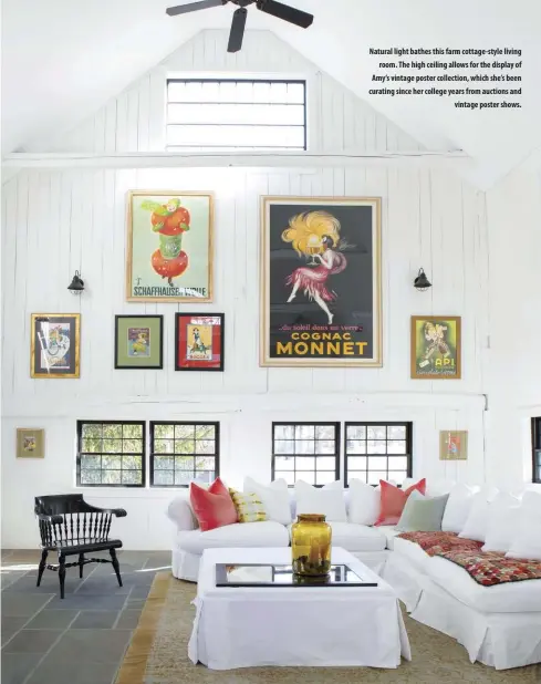  ??  ?? Natural light bathes this farm cottage-style living
room. The high ceiling allows for the display of Amy’s vintage poster collection, which she’s been curating since her college years from auctions and
vintage poster shows.