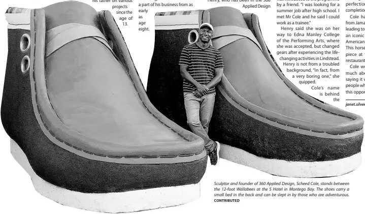  ?? CONTRIBUTE­D ?? Sculptor and founder of 360 Applied Design, Scheed Cole, stands between the 12-foot Wallabees at the S Hotel in Montego Bay. The shoes carry a small bed in the back and can be slept in by those who are adventurou­s.