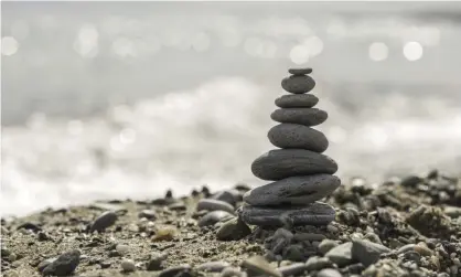  ?? Photograph: Alamy Stock Photo ?? Balancing stones is a popular activity among lovers of the outdoors.