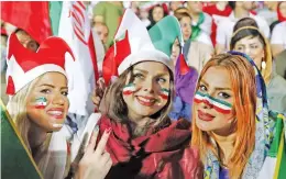  ?? — AFP ?? Iranian women watch the Group ‘B’ match between Portugal and Iran at Azadi stadium in Tehran on Monday night.