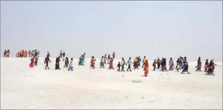  ?? ANI ?? Voters on their way to a polling station in Darrang, Assam on Friday.