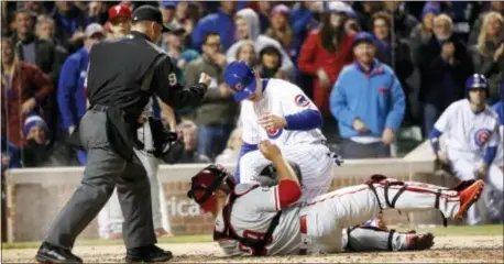  ?? CHARLES REX ARBOGAST — THE ASSOCIATED PRESS ?? Home plate umpire Toby Basner calls the Cubs’ Anthony Rizzo out at home after Phillies catcher Cameron Rupp took a throw from second baseman Cesar Hernandez during the fourth inning Tuesday in Chicago.