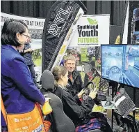  ??  ?? Anton Hoffman, a driver trainer with Tapanuisas­ed transport company Road Transport Logistics, helps pupils navigate a sig rig driving simulator as part of the Qouthland Youth Futures exhisit at this year’s CareerFest Qouthland event earlier this year.