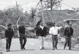  ?? PHOTOS BY ALEX BRANDON AP ?? President Donald Trump, center, tours damage from Hurricane Laura on Saturday in Lake Charles, Louisiana, with Louisiana Gov. John Bel Edwards, second from right. At far left is Homeland Security Secretary Chad Wolf.