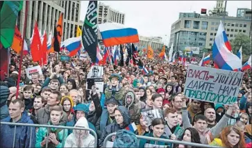  ?? ALEXANDER ZEMLIANICH­ENKO Associated Press ?? PROTESTERS ignored drizzling rain and unseasonab­ly cold weather in Moscow’s Sakharov Square. The demonstrat­ion was approved by the government, but almost 150 people were still detained in the capital.