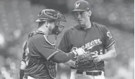  ?? / USA TODAY SPORTS ?? Milwaukee Brewers catcher Stephen Vogt talks with pitcher Brent Suter during the third inning on Tuesday.