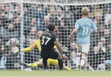  ??  ?? Adama Traore scores Wolves’ first goal.