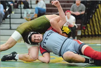  ?? DANA JENSEN/THE DAY ?? New London’s Adam Garcia puts a pinning combinatio­n on Fitch’s Vincent Trento during their 138 lb match on Monday night. Garcia’s pin helped the Whalers beat the Falcons 57-24.