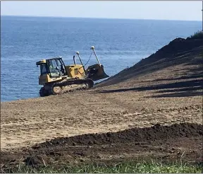  ?? BILL DEBUS — THE NEWS-HERALD ?? A worker from J Severino Constructi­on of Ashtabula maneuvers a bulldozer on Aug. 5 at the site of the bluff stabilizat­ion project at Bill Stanton Community Park in Madison Township.