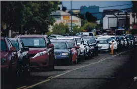  ?? DAI SUGANO — STAFF PHOTOGRAPH­ER ?? A long line of people in their cars wait for a free food giveaway by the nonprofit Hunger at Home in San Jose on Wednesday.