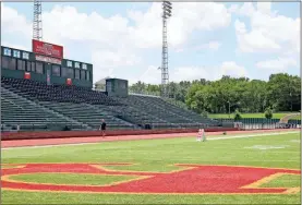  ?? / John Bailey ?? Funding to replace the astro turf at Barron Stadium is included in the 2017 SPLOST. Walkers use the track at the stadium even during the hottest part of the day.