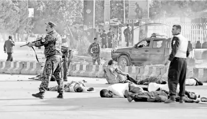  ??  ?? Victims lie on the ground at the site of a blast in Kabul. — Reuters photo