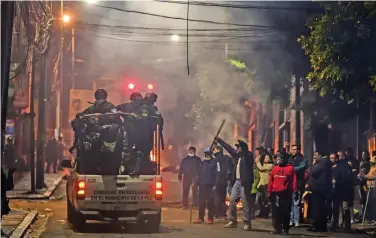  ??  ?? Policemen patrol the streets in La Paz as chaos spreads in Bolivia after former president Evo Morales (right) leaves the country in an aircraft of the Mexican Air Force on Monday