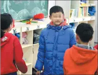  ?? JI WANG AND LUO HAO / FOR CHINA DAILY ?? Xiaolei (center) with his classmates at Jilin Orphan School in Changchun, Jilin province.