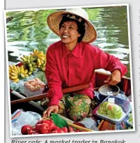  ??  ?? River cafe: A market trader in Bangkok