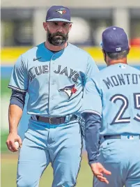  ?? MIKE CARLSON THE ASSOCIATED PRESS ?? Blue Jays manager Charlie Montoyo arrives with the hook after a wild ninth inning performanc­e by reliever Tyler Chatwood.