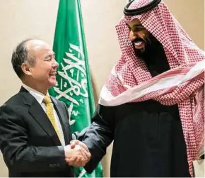  ?? BLOOMBERG PIC ?? SoftBank Group Corp chief executive officer Masayoshi Son (left) with Saudi Crown Prince Mohammed Salman in New York early this year. The Public Investment Fund, which is chaired by the prince, is looking to transform itself into the world’s largest sovereign fund.