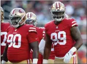  ?? JANE TYSKA — BAY AREA NEWS GROUP ?? DeForest Buckner (99) and Earl Mitchell (90) warm up before their preseason game against the Cowboys at Levi’s Stadium in Santa Clara on Aug. 9, 2018.