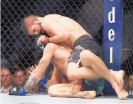  ?? JOHN LOCHER/ASSOCIATED PRESS ?? Khabib Nurmagomed­ov, top, belabors Conor McGregor during the main event of UFC 229 in Las Vegas, Nev. Nurmagomed­ov won by fourth-round submission.