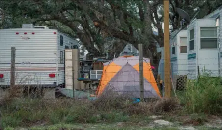  ?? KIM PORTER VIA AP ?? In this photo provided by Kim Porter, shows people living in tents and trailers in Rockport, Texas. The federal government typically spends up to $150,000 apiece — not counting utilities, maintenanc­e or labor — on the trailers it leases to disaster...