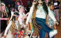  ?? COURTESY OF MAJID BASSERY ?? va and Andrea Sanders dance the night away in their colorful outfits at the Boogie Wonder Ball.