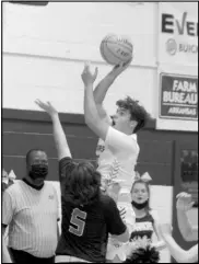  ?? Photo by Gerren Smith ?? AGGRESSIVE PLAY AT THE BASKET: Ouachita Warrior Tanner Furr (30) showcases aggressive scoring ability in the post area against the Benton Harmony Grove defense during hoop action at Ouachita High School Gymnasium.