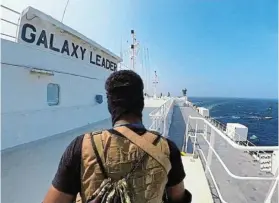  ?? Picture: REUTERS ?? A Houthi fighter stands on the Galaxy Leader cargo ship in the Red Sea in this photo released by the Houthi Military Media. The Houthis have been attacking ships in the Red Sea recently
