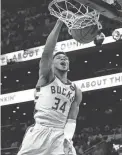  ?? STEVEN SENNE/AP ?? Bucks forward Giannis Antetokoun­mpo dunks against the Celtics on Sunday.