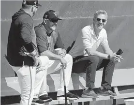  ?? LLOYD FOX/BALTIMORE SUN ?? Orioles manager Brandon Hyde and general manager Mike Elias watch bullpen sessions during spring training at the Ed Smith Stadium complex.