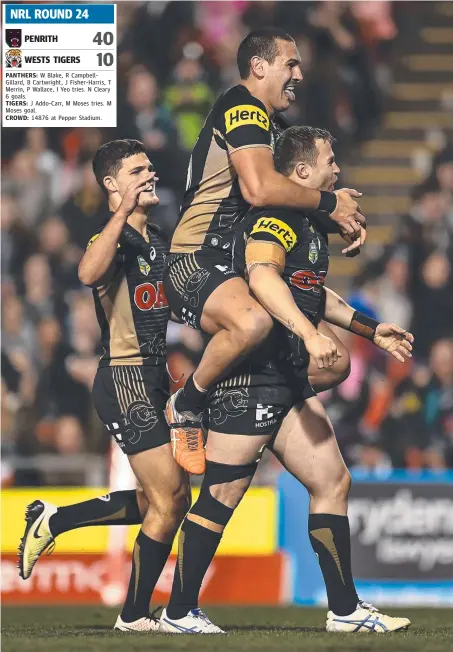  ?? Picture: GETTY IMAGES ?? Trent Merrin of the Panthers celebrates scoring a try with his teammates during last night’s win over the Tigers.