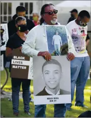  ?? JANE TYSKA — STAFF ARCHIVES ?? Rick Perez, of Richmond, holds a picture of his son, top, and of Miles Hall during the “Justice for Miles Hall Rally and Tribute” at Civic Park in Walnut Creek on July 1, 2020.