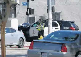  ?? Christian K. Lee Los Angeles Times ?? A POLICE VEHICLE sits wrecked near 77th and San Pedro streets after three cadets in stolen cruisers led officers on chases through Los Angeles on June 14.