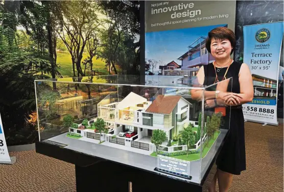  ??  ?? Lim showing a model of the double-storey terrace homes at the Bukit Impian Residence.