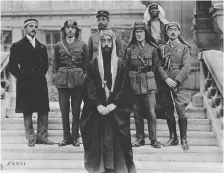  ?? (Wikimedia Commons) ?? KING FAISAL of the Hashemite Arab Kingdom (front) with T. E. Lawrence (2nd R) and the Hejazi delegation at the post-World War I Paris Peace Conference, 1919.