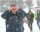  ?? MICHAEL SEARS / MILWAUKEE JOURNAL SENTINEL ?? Randy Medd of Oconomowoc shields his eyes from blowing snow as he makes his way from the parking lot to the Exposition Center at State Fair Park for the NARI Spring Home Improvemen­t Show on Sunday.