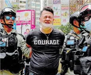  ?? VINCENT YU THE ASSOCIATED PRESS ?? About 370 people were arrested during and after Wednesday’s protests in Hong Kong, including 10 on suspicion of violating the new national security law.