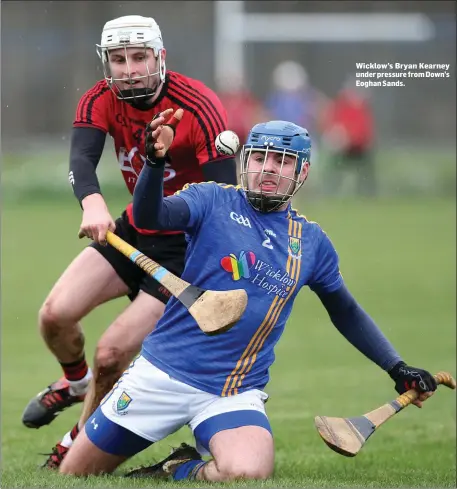  ??  ?? Wicklow’s Bryan Kearney under pressure from Down’s Eoghan Sands.